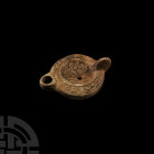 Roman Lamp with a Fantastic Beast by Quintus Ivstvs
3rd-4th century A.D. A ceramic oil lamp with broad body and short nozzle, lug handle to the rear;...