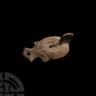 Roman Herodian Oil Lamp with Winged God
1st century B.C.-1st century A.D. A large ceramic oil lamp with large pierced lug handle, broad body and volu...