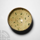 Byzantine Sgraffito Glazed Bowl
12th-15th century A.D. A conical bowl with inverted rim and plinth foot, glazed interior and exterior rim, geometric ...