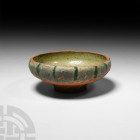 Byzantine Glazed Bowl
Circa 14th-15th century A.D. A conical bowl with inverted rim, shallow foot and decorative glaze. 88 grams, 10 cm wide (4 in.)....