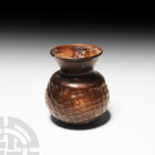 Byzantine Mould Blown Aubergine Glass Jar
5th-8th century A.D. A mould-blown aubergine glass jar or flask with bulbous body featuring a 'net' design ...