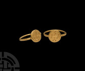 Byzantine Gold Ring with Monogram
6th-7th century A.D. A gold ring with round-section hoop and discoid bezel with incuse cross monogram. Cf. Chadour,...