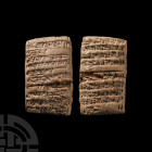 AKKADIAN CUNEIFORM ADMINISTRATIVE TABLET.
18TH CENTURY B.C. A ceramic pillow-shaped tablet with biconvex cross-section; displaying impressed cuneifor...