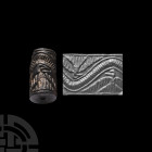 Western Asiatic Cylinder Seal with Eagles Below Linear Heavens
4th-2nd millennium B.C. A black limestone cylinder seal bearing a geometric zoomorphic...
