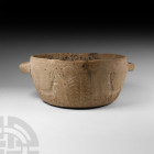 Bactrian Bowl with Animal Decoration
2nd millennium B.C. A large carved ceramic bowl with cylindrical body and lug handles, reserved stylised images ...