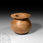 Mesopotamian Speckled Jasper Vessel
2nd millennium B.C. A squat globular speckled yellow jasper vessel, flattened disc rim with raised circumferentia...