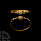 Sarmatian Gold Bracelet with Gemstones
2nd-3rd century A.D. A gold bracelet composed of a D-section hoop terminating in corrugated sleeves, the oval ...