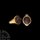 Sassanian Gold Ring with Advancing Figure Gemstone
5th-6th century A.D. A gold finger ring with flared shoulders to the hoop, discoid cell to the bez...