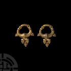 Parthian Gold Earring Pair
3rd century B.C.-3rd century A.D. A matching pair of gold hoop earrings, each composed of a tapering hoop with expanded ce...
