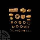 Western Asiatic Gold Bead Collection
1st millennium B.C. A mixed group of over 20 gold beads of various types, including hollow-formed, ribbed and gr...