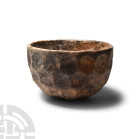 Sassanian Brown Cut Glass Vessel
3rd-7th century A.D. A hemispherical, opaque brown glass bowl or cup with four decorative tiers of cut facets. Cf. W...
