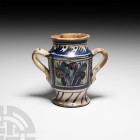 Medieval Maiolica Albarello with Gothic Foliage
Italy, late 15th century A.D. A tin-glazed earthenware albarello featuring two handles and blue, gree...