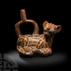 Pre-Columbian Moche Snarling Pampas Vessel
4th-7th century A.D. A bichrome ceramic stirrup bottle in the form of a spotted feline, likely a pampas ca...