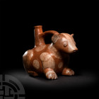 Pre-Columbian Moche Canine Stirrup Vessel
3rd-8th century A.D. A bichrome ceramic bottle in the form of a couchant animal, possibly a canine, with st...