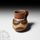 Pre-Columbian Geometric Juglet
16th century A.D. or earlier. A polychrome ceramic juglet with integral handle, decorated with scallops, swags and pel...