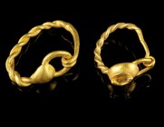 Roman Gold Earrings
1st-2nd century CE
Gold, 15-18 mm, 2,70 g
Two gold earrings with twisted wire hoop and decorative shield on the front.
Excelle...