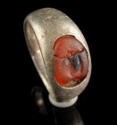Roman Silver Ring With Carnelian Intaglio
1st-3rd century CE
Silver, Carnelian, 21 mm overall, 17 mm internal diameter, 6,08 g
Intact and wearable....
