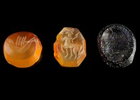 Lot of 3 Roman Gems/Intaglios
2nd-4th century CE
Carnelian, Glas, 11-13 mm, 0,38-0,94 g
Roman Intaglios engraved with a dissolved head, a bird(?) a...