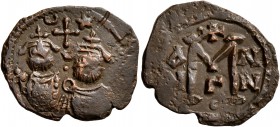 ISLAMIC, Time of the Rashidun. Pseudo-Byzantine types. Fals (Bronze, 21 mm, 2.84 g, 11 h), uncertain mint, circa 29-49 AH / 650-670 AD. Two bearded im...