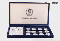 Kassette "Olympische Spiele 1988", darin 12 Silbermünzen, dabei Kanada 20 Dollars und Bulgarien 10 Lewa, verkapselt, PP, teilweise berührt und Kapseln...