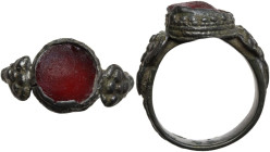Silver ring with red glass inlay, shoulders decorated. Middle Ages. Inner diameter: 18 mm.
