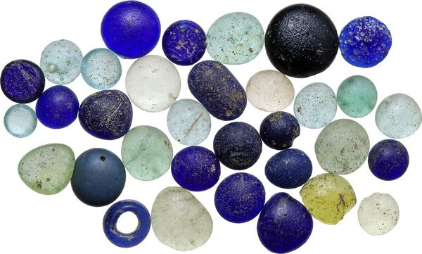 Lot of thirty-three (33) glass inlays and beads. Ancient to Medieval.