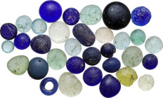 Lot of thirty-three (33) glass inlays and beads. Ancient to Medieval.