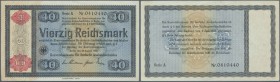 Reichskonversionskasse: 40 Reichsmark 1934, mit Heftlöchern, ohne Perforation, Ro.711 mit rostigen Spuren einer Büroklammer und Knickstellen an den Ec...