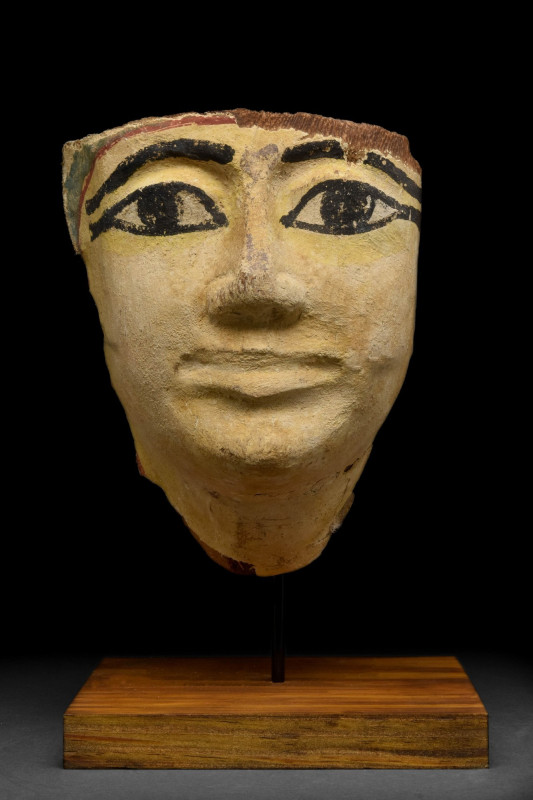 EGYPTIAN WOOD GESSO PAINTED COFFIN MASK
Third Intermediate Period, Ca. 1069-730...