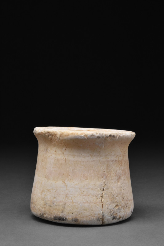 BACTRIAN ALABASTER VESSEL
Ca. 3000 BC. A cream-coloured alabaster vessel with a...