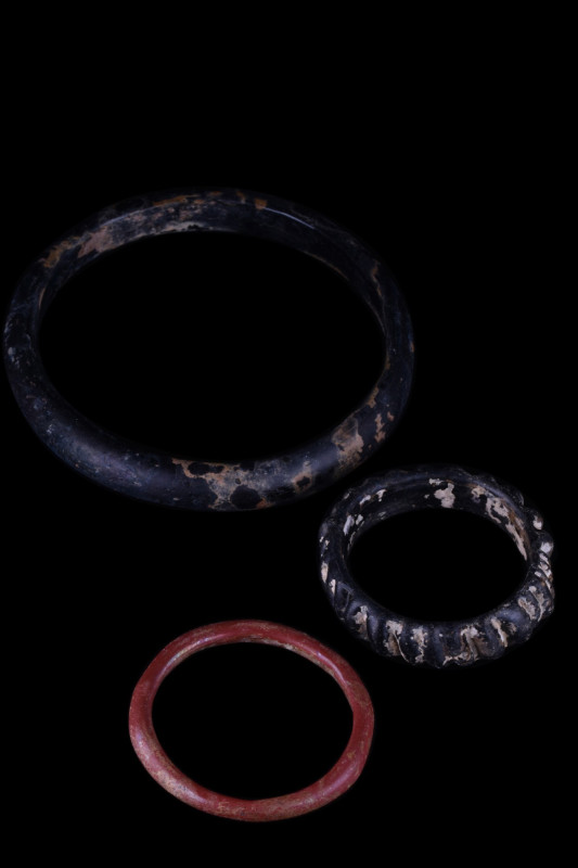 COLLECTION OF THREE ROMAN GLASS BRACELETS
Late Roman, Ca. 300-500 AD. A group o...