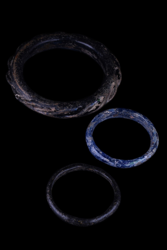 COLLECTION OF THREE ROMAN GLASS BRACELETS
Late Roman, Ca. 300-500 AD. A group o...