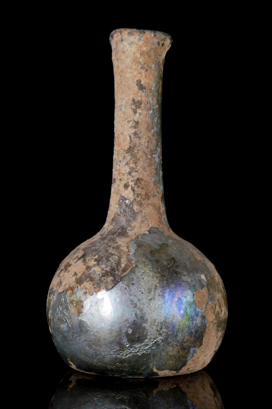 A ROMAN IRIDESCENT GLASS BOTTLE
Ca. 100-200 AD. An elegant glass bottle with ir...