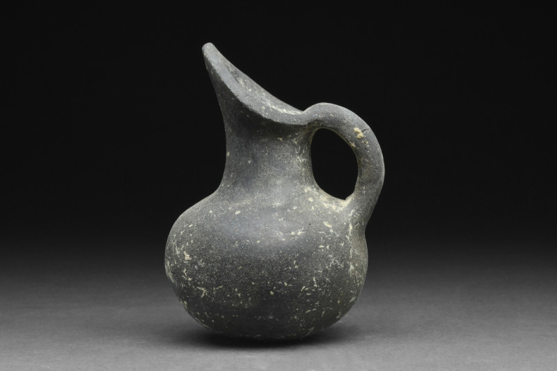 ANATOLIAN YORTAN POTTERY JUG
Ca. 2700-2400 BC. A wheel-thrown blackware jug wit...