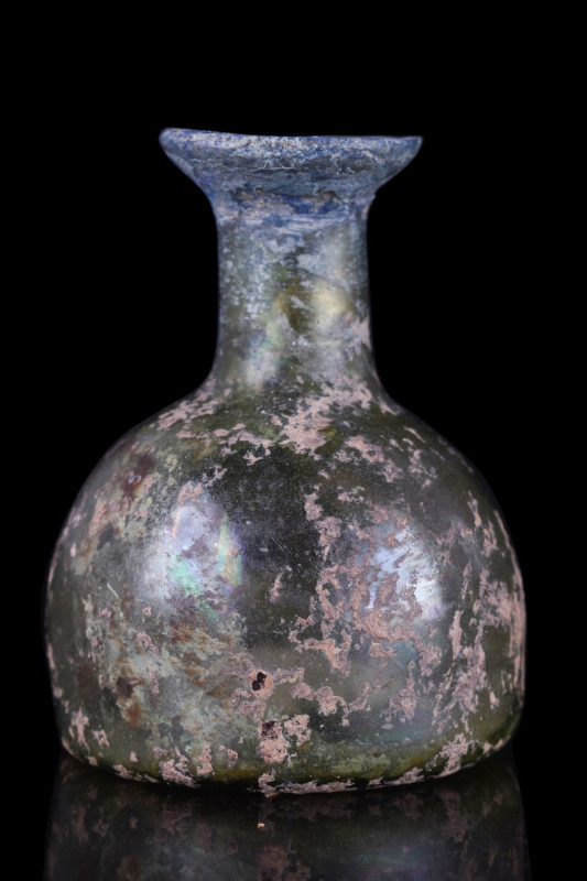 ANCIENT ROMAN GLASS FLASK
Ca. 100-300 AD. A free-blown glass flask of a dome-sh...