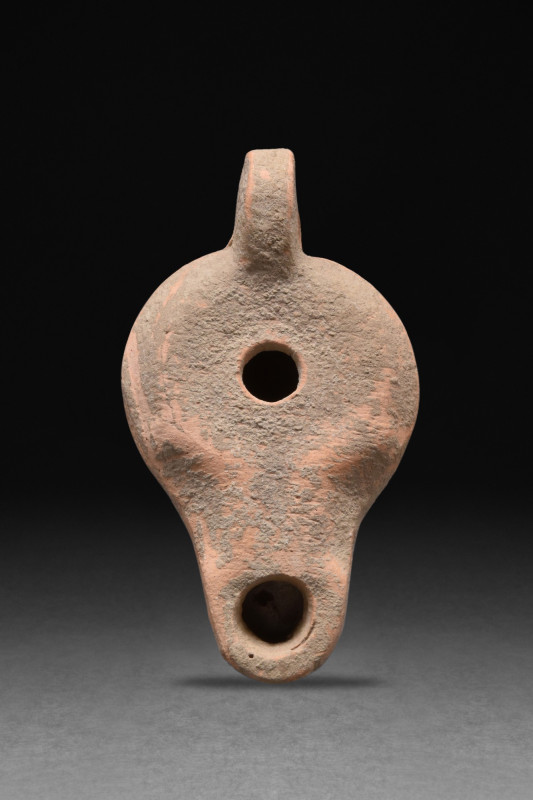 ROMAN TERRACOTTA OIL LAMP
Ca. 1-200 AD. A terracotta oil lamp with a globular b...