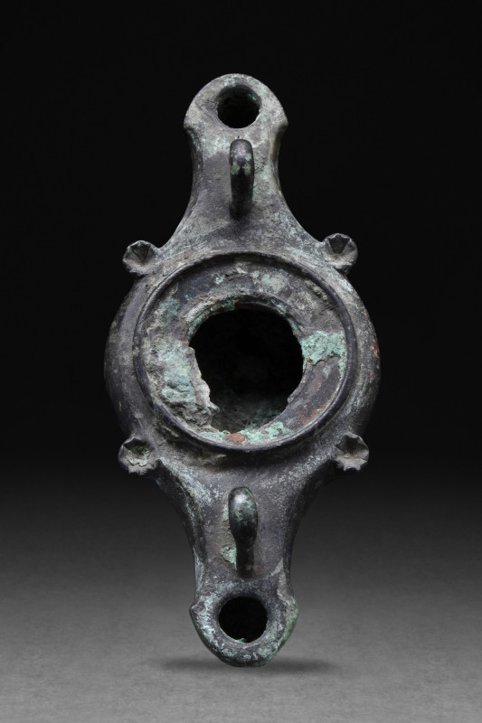 ROMAN BRONZE OIL LAMP WITH SWAN HEADS
Ca. 100-200 AD. A beautiful bronze oil la...