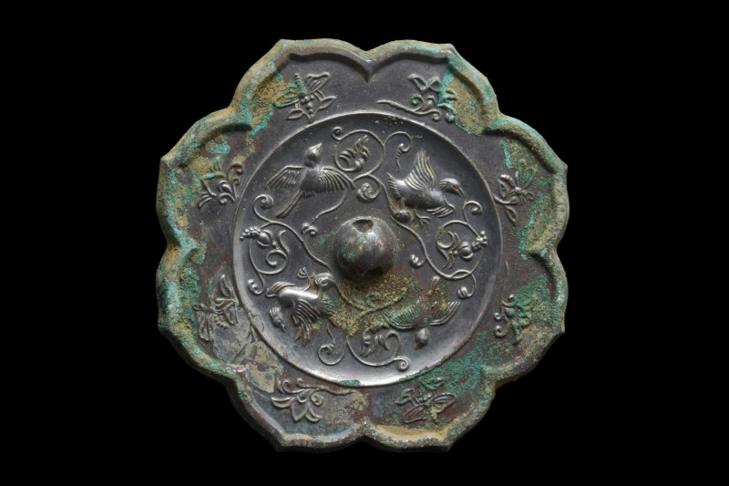 CHINESE TANG DYNASTY BRONZE MIRROR WITH BIRDS
Ca. 618-907 AD. A rosette-shaped ...