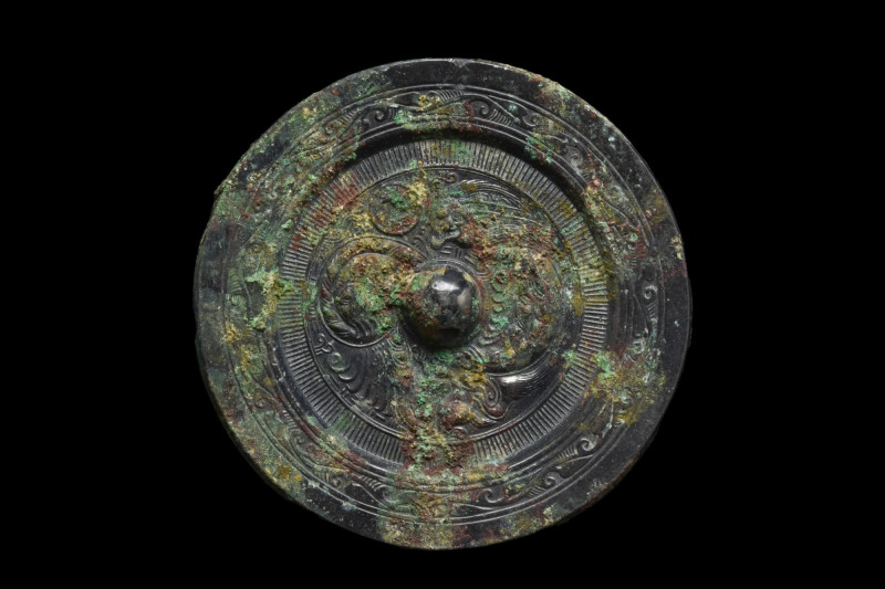 CHINESE TANG DYNASTY BRONZE DECORATED MIRROR
Ca. 618-907 AD. A circular bronze ...