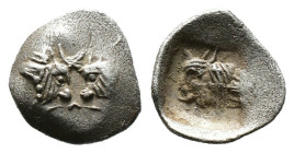 (Silver, 0.13g 7mm) CARIA. Uncertain. Circa 450-400 BC. Tetartemorion
Confronted foreparts of two bulls with crossed horns.
Rev. Head of a bull to lef...