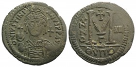 Justinian I (527-565). Æ 40 Nummi (41mm, 22.62g, 6h). Theoupolis (Antioch), year 13 (539-540). Helmeted, pearl-diademed and cuirassed bust facing, hol...