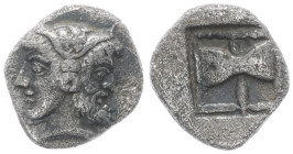Troas, Tenedos. AR Obol, 0.56 g 8.64 mm. Circa 5th Century BC. 
Obv: Janiform head, female on left, male on right 
Rev: Labrys (double axe) within inc...
