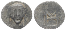 Ionia, Kolophon. AR Hemiobol, 0.41 g 8.94 mm. Circa 450-410 BC. 
Obv: Facing laureate head of Apollo between two laurel leafs.
Rev: Monogram of HM (ma...