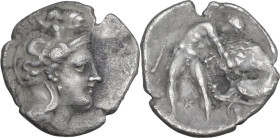 Greek Italy. Southern Apulia, Tarentum. AR Diobol, c. 380-325 BC. Obv. Helmeted head of Athena right, helmet decorated with Scylla hurling rock. Rev. ...