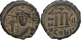 Tiberius II Constantine (578-582). AE Follis. Constantinople mint, 3rd officina. Dated RY 7 (580/1). Obv. Crowned bust facing, wearing consular robes,...