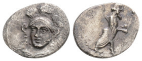 CILICIA. Uncertain. Obol (4th century BC).
Obv: Helmeted head of Athena facing slightly left.
Rev: Persian king(?) standing right, holding staff and a...