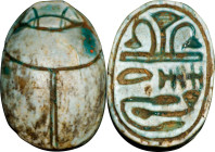Egyptian Steatite Scarab. New Kingdom, 18th Dynasty, ca. 1550-1292 B.C. 1.39 gms. VERY FINE.
Diameter: 14mm. Well-cut, with a light green glaze and i...