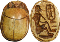 Egyptian Steatite Scarab. New Kingdom, ca. 1550-1069 B.C. 1.82 gms. VERY FINE.
Diameter: 16mm. With a light brown glaze, incised with a seated figure...