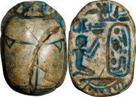 Egyptian Steatite Scarab. New Kingdom, ca. 1550-1069 B.C. 1.49 gms. FINE.
Diameter: 15 mm. With a greenish blue glaze, incised with a kneeling figure...