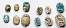 Group of Six Egyptian Glazed Steatite Scarabs. New Kingdom, 18th Dynasty, ca. 1550-1292 B.C. Average Grade: FINE.
Comprising a ram head of Amun flank...
